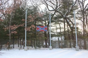 In this picture from February of 2016, the confederate flag overlooks the athletic facilities while the school committee banners were down for the winter. (Photo/Ellie Kalemkeridis)