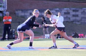 Junior Melanie Weber faces off against Wellesley during their game on April 14 (Photo/ Hiromi Kondo).