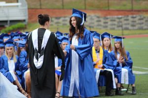 Angela accepts her diploma at the graduation ceremony (Photo/ Mandy Scully)