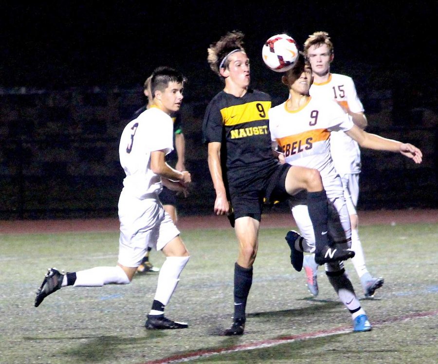Senior Luccas Ferreira goes up for the header against Nausets Ethan Craven. 