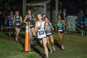 Freshman Cara Morris, Walpole's 7th runner, works to stay ahead of a pack of competitors (Photo/ David Forester).