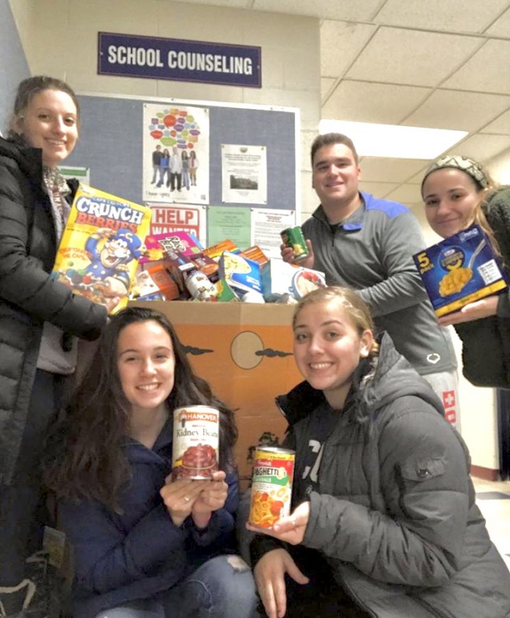 Beside the donations, Doherty, Zagami and Sampson pose along-
side other club members McKayla Preto and Matt Ferraro.