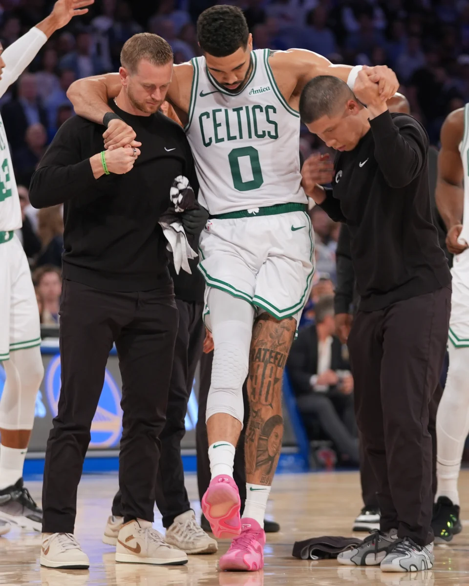 Jayson Tatum being walked off the court after tearing his achilles